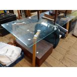 A 1.1m modern glass topped coffee table, set on L-shaped blonde wood legs