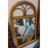 A modern bamboo and bound framed oblong wall mirror with arched pediment