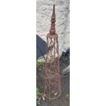 A wrought iron garden obelisk with spiked finial to top