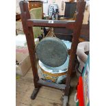 A late Victorian stained wood framed freestanding dinner gong with chamfered square supports and