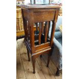 An early 20th Century polished oak pedestal stand with shaped lathe sides to open central section,