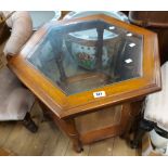 A 62cm modern stained wood hexagonal two tier tea table with inset bevelled glass top, set on