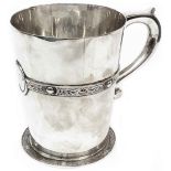 A silver tankard with cast Celtic style strap banding, scroll handle and initials to cartouche, by