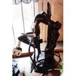 A modern resin table lamp depicting a maiden with flowing hair with bronze effect finish