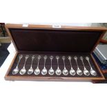 A wooden cased set of twelve silver teaspoons with named gilt bird decorated terminals 'The Royal