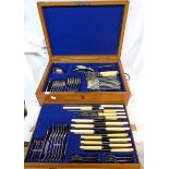 An early 20th Century oak canteen containing a six place setting of silver plated cutlery and