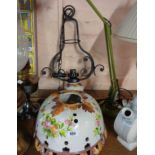 A wrought iron and pottery electric hanging ceiling lamp of oil lamp form, the large tin glaze