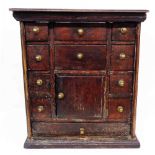 A 40cm antique oak wall hanging spice chest with an array of short drawers, cupboard and long drawer