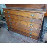 A 1.2m vintage oak two part plan chest with flight of six shallow drawers with brass cup handles and