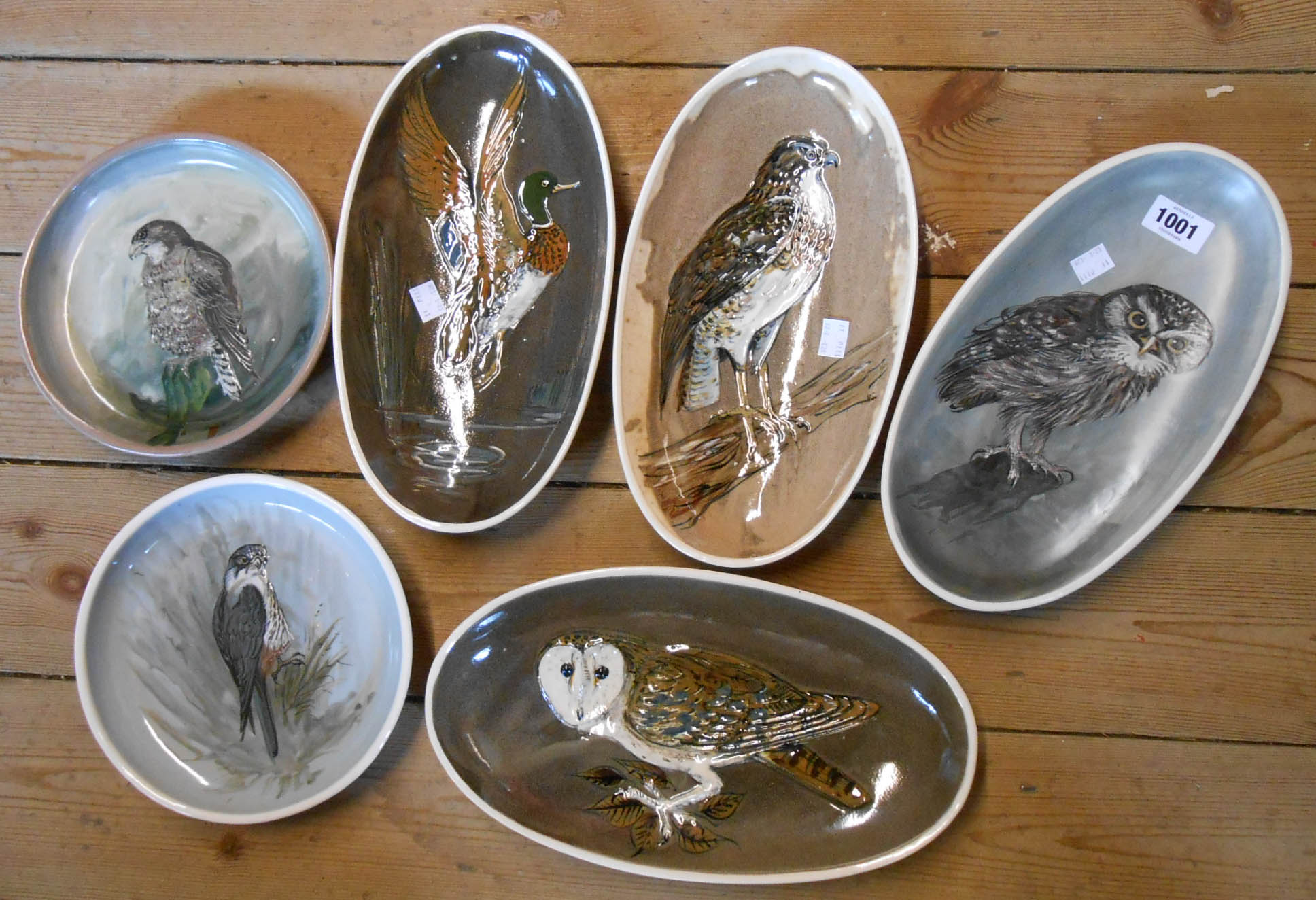 Four Stuart Bass (Exmoor) pottery oval dishes, each decorated in sgraffito and slip with a bird