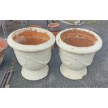 A pair of large terracotta garden planters of urn form with cream painted finish