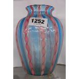 A vintage Venetian glass vase with internal pink candy twist decoration on a light blue ground