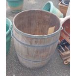 A large old coopered grain barrel with flanking handles