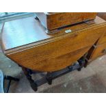 A 73cm 20th Century oak gateleg dining table, set on barley twist supports