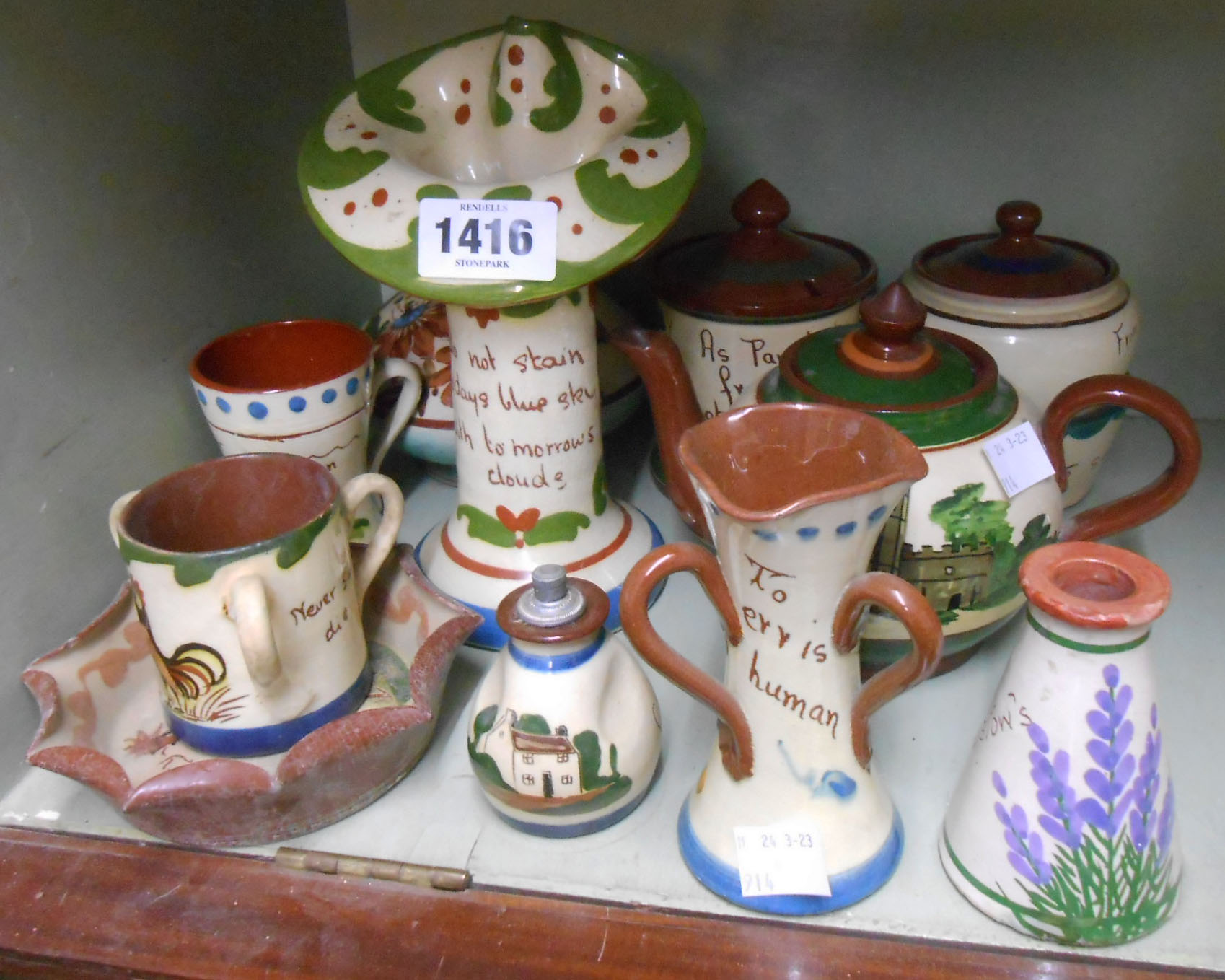 A quantity of mainly motto ware Torquay pottery items including teapot, vases, miniature tyg, etc. -