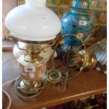 A vintage electric table lamp of oil lamp form with central ceramic 'reservoir' and opaque glass