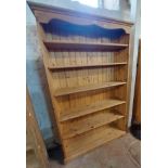 A 1.15m modern pine freestanding open bookcase with five adjustable shelves and shaped base - 1.