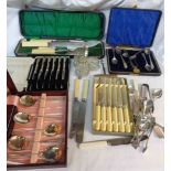 A box containing a quantity of assorted silver plated items including cased cutlery, condiment