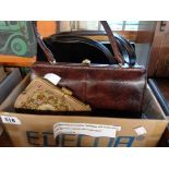 A box containing three vintage handbags comprising a Waldybag black patent leather example with