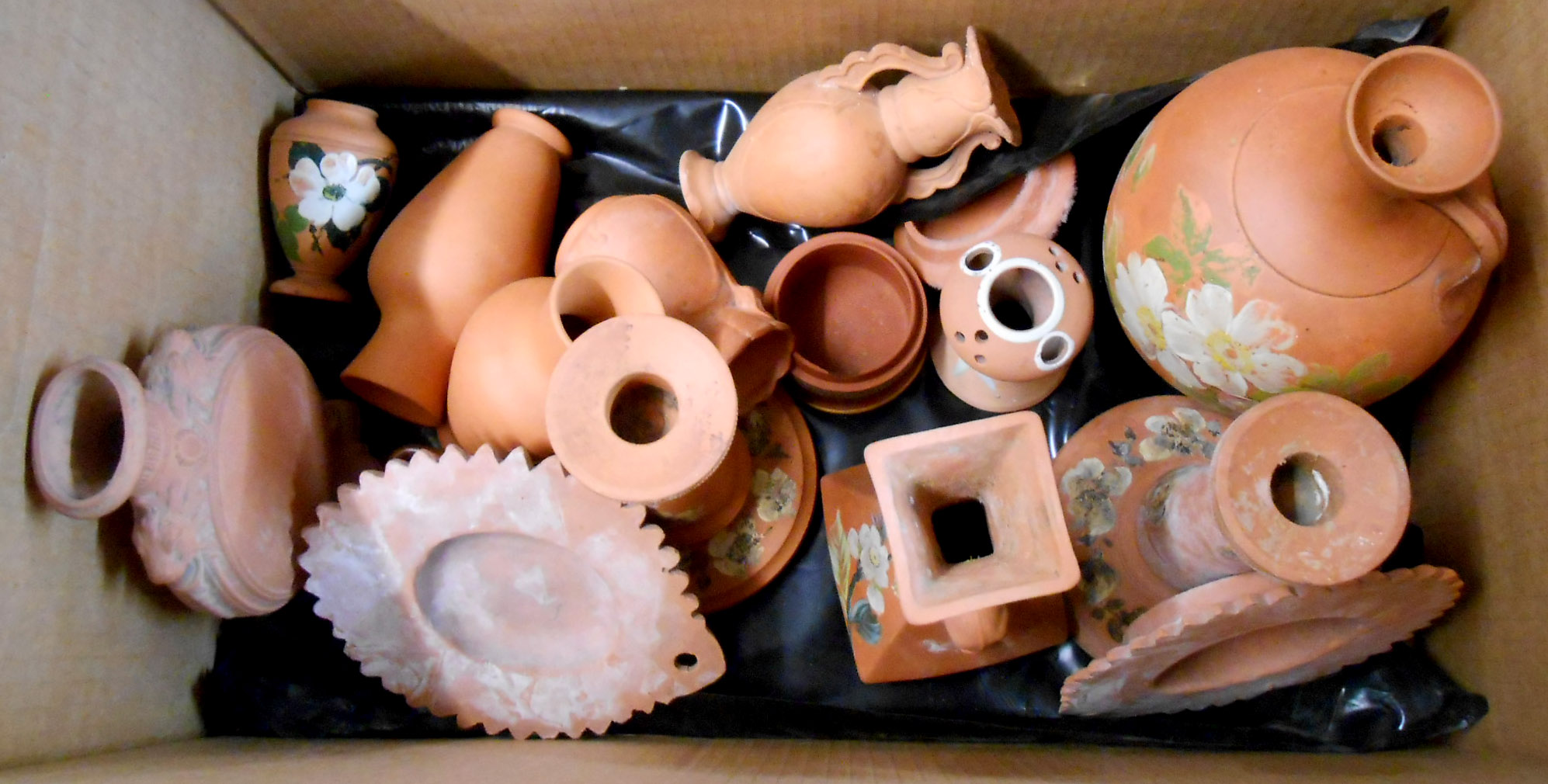 A box containing a quantity of Torquay painted terracotta ware including jugs, wall hangings, vases,