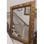 A vintage giltwood framed bevelled oblong wall mirror with pierced and carved decoration