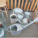 A quantity of assorted vintage galvanised items including watering cans, etc.