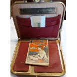 A vintage travelling writing case with fitted interior and red leatherette covering - sold with an