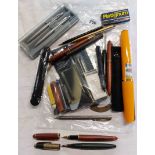 A bag containing a quantity of fountain pens, refills, etc. including Wyburn, oversized souvenir