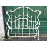 A modern cast iron Laura Ashley bed with decorative scrolling and white painted finish