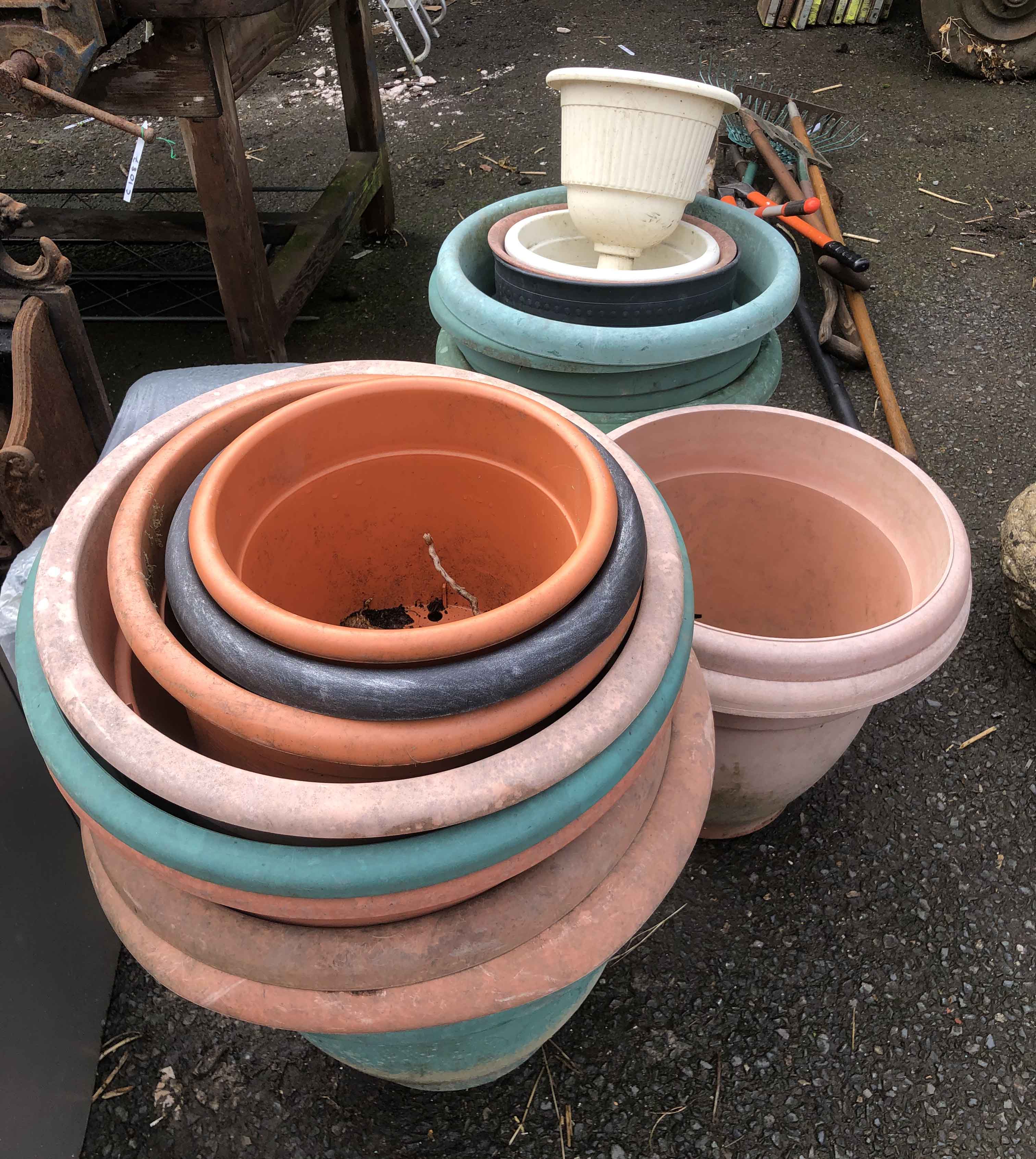 A large quantity of plastic garden pots and planters