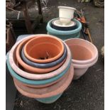 A large quantity of plastic garden pots and planters