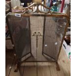 A brass frame and mesh three fold fire guard