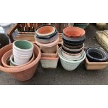 A large quantity of plastic garden pots and planters