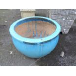 A large blue glazed garden planter