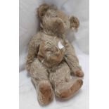 An antique straw filled teddy bear with internal push action musical movement - a/f