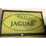 A modern stencilled wooden Jaguar car sign