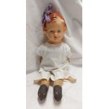 A vintage Reliable doll with composition head and arms and cloth body