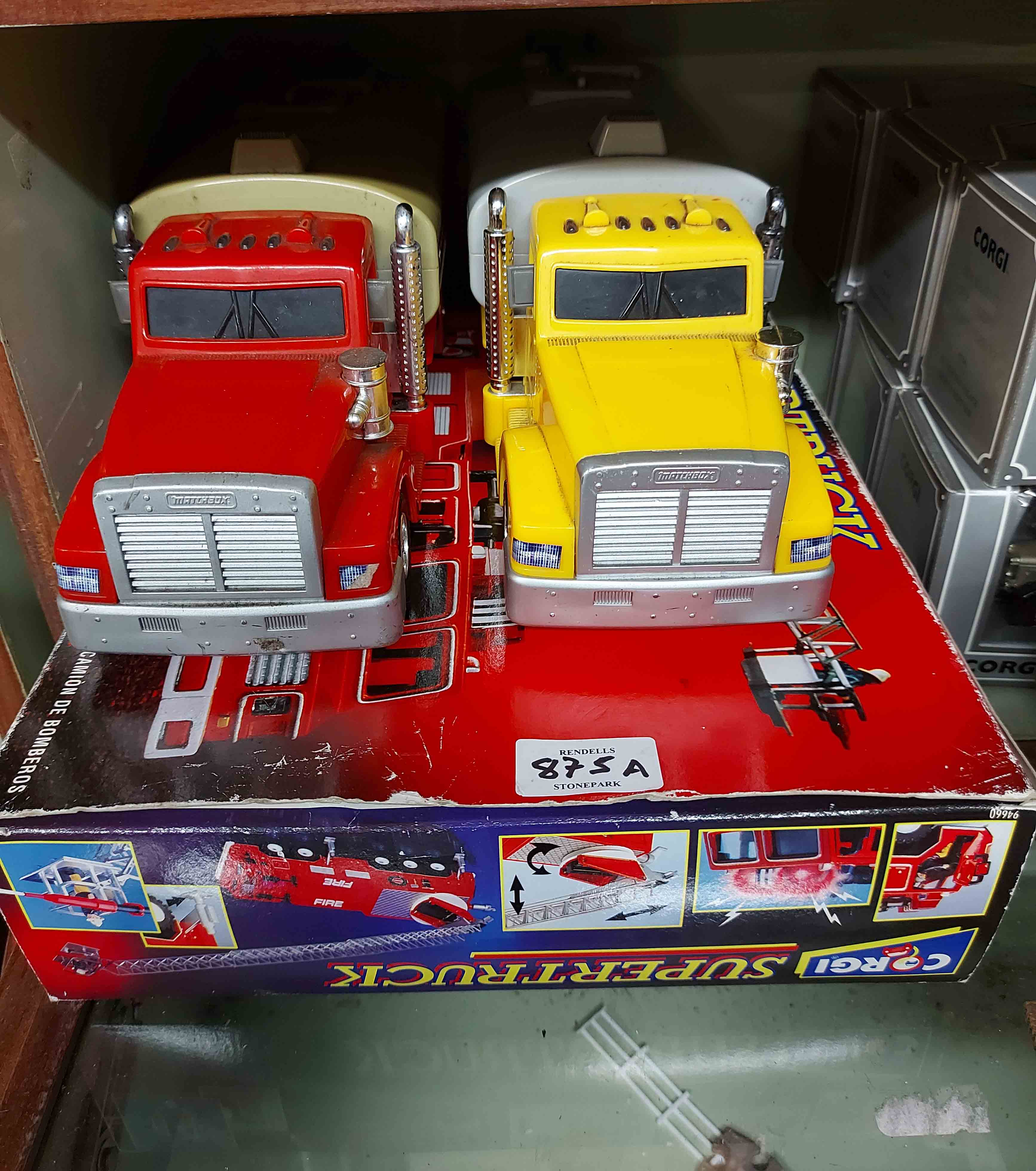 A bag containing a boxed Corgi Supertrucks fire engine and two other model trucks