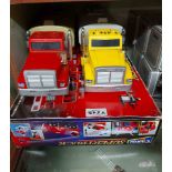 A bag containing a boxed Corgi Supertrucks fire engine and two other model trucks