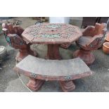 A Chinese style cast concrete garden set comprising table, two chairs and two benches with green and