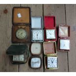 A collection of vintage small alarm clocks and timepieces including Swiza, Jughans and Kienzle, etc.