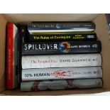 A box containing a small collection of modern medical and other books