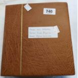 A brown ring bound folder containing French and colonies coins in plastic sleeves