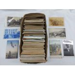 A shoe box containing early 20th Century and later postcards including foreign travel, greetings,
