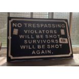 A modern painted cast iron No Trespassing sign