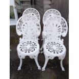 Four cast aluminium garden chairs in the antique style