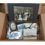 A box containing a quantity of late Victorian and later family photographs framed and unframed