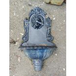 A modern painted cast iron garden fountain head of lion mask form