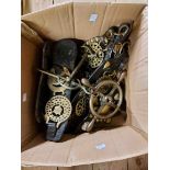 A box containing a quantity of antique horse brasses on leather straps including heart shaped R.W.H.