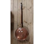 An antique copper warming pan